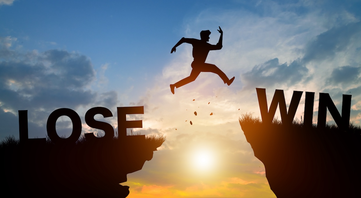 man jumping across mountain