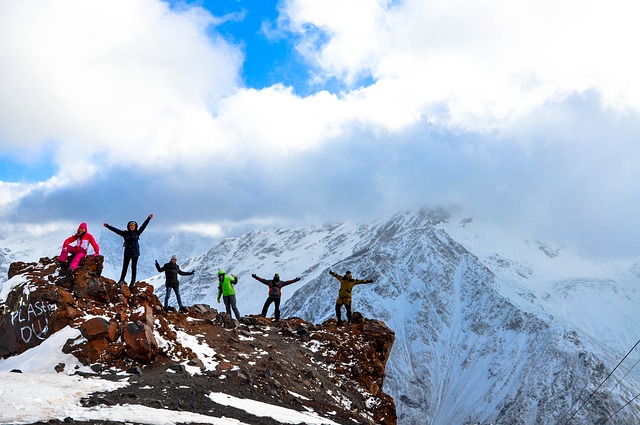 people standing on mountain top